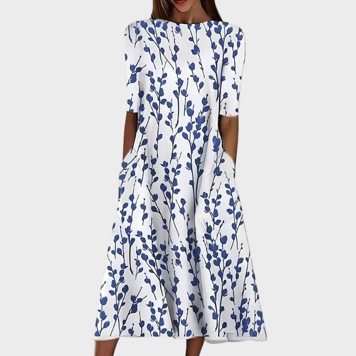 Sela – Vestido midi con flores junto al mar
