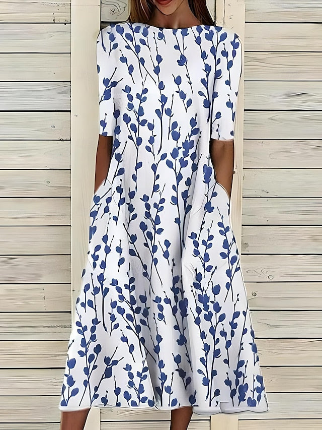 Sela – Vestido midi con flores junto al mar
