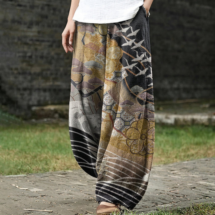 Coralie – Pantalón ancho dorado con estampado de grullas y nubes