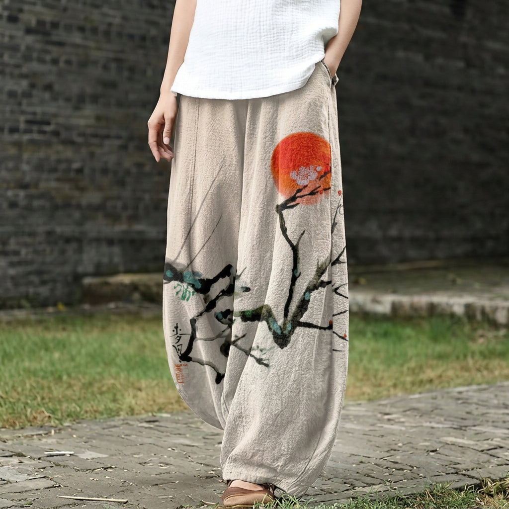 Léonie – Pantalón ancho beige con motivo de sol en tinta